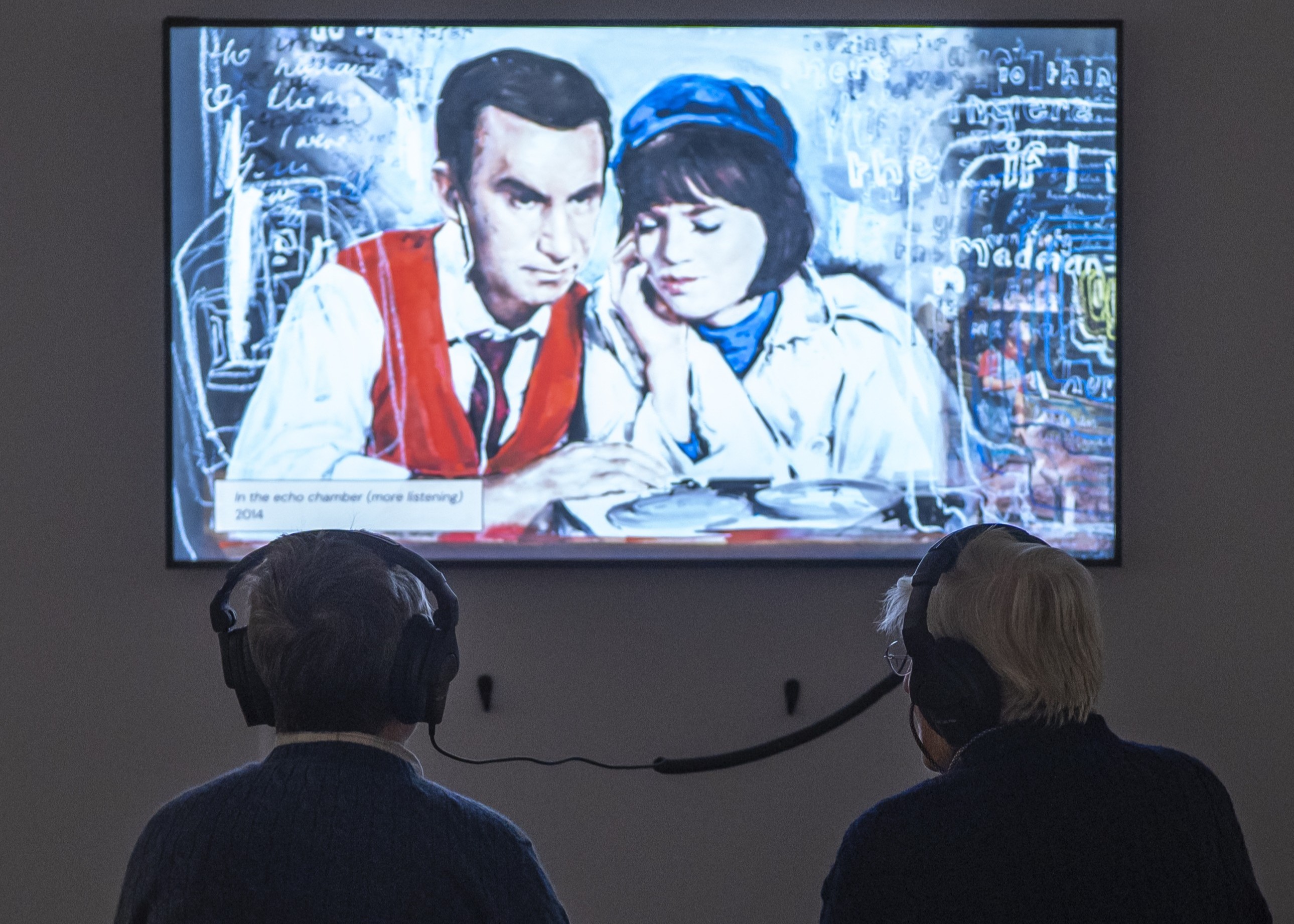 two people watching a tv showing a painting of a scene from get Smart