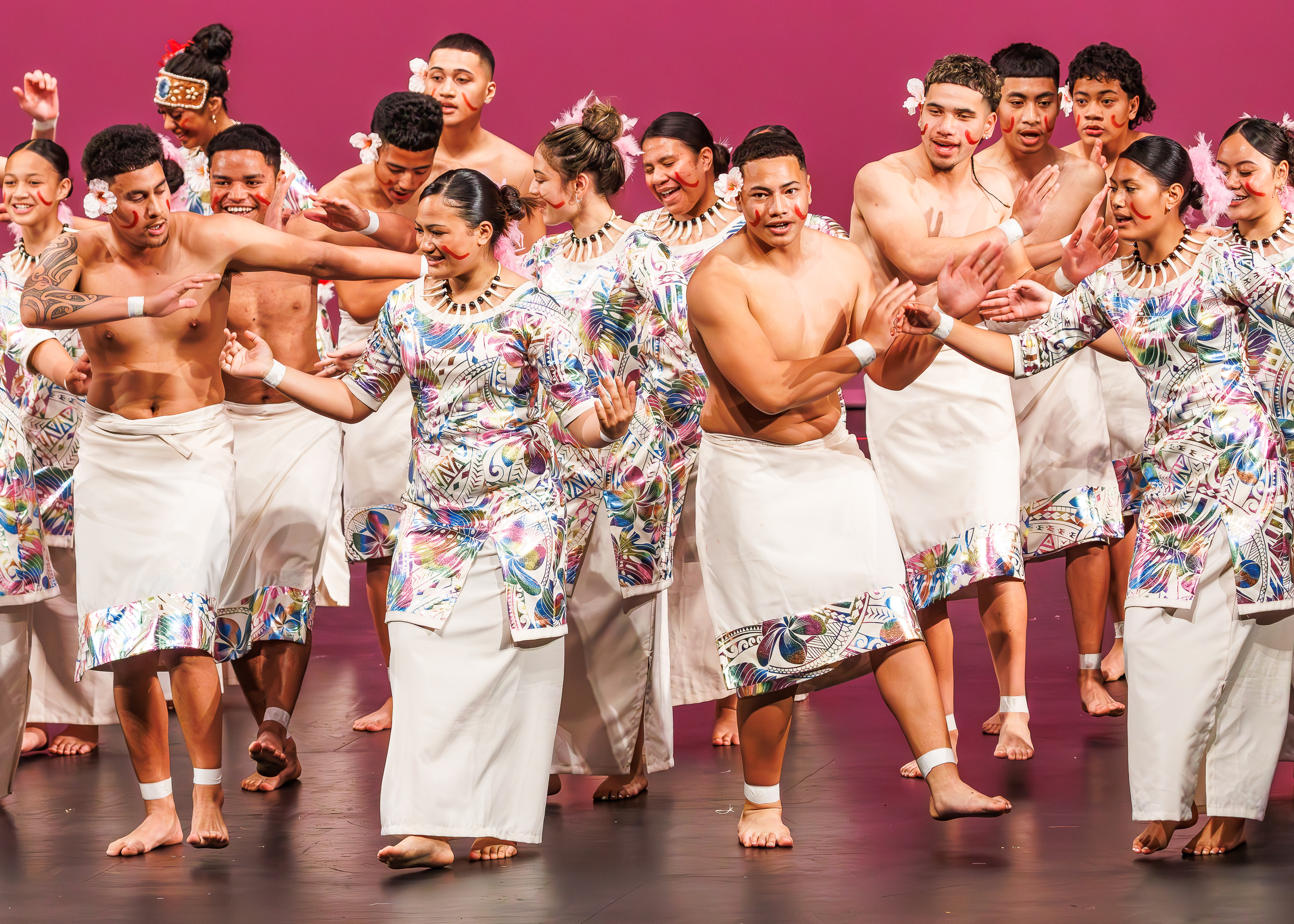 Young people dancing on stage in traditional costume 