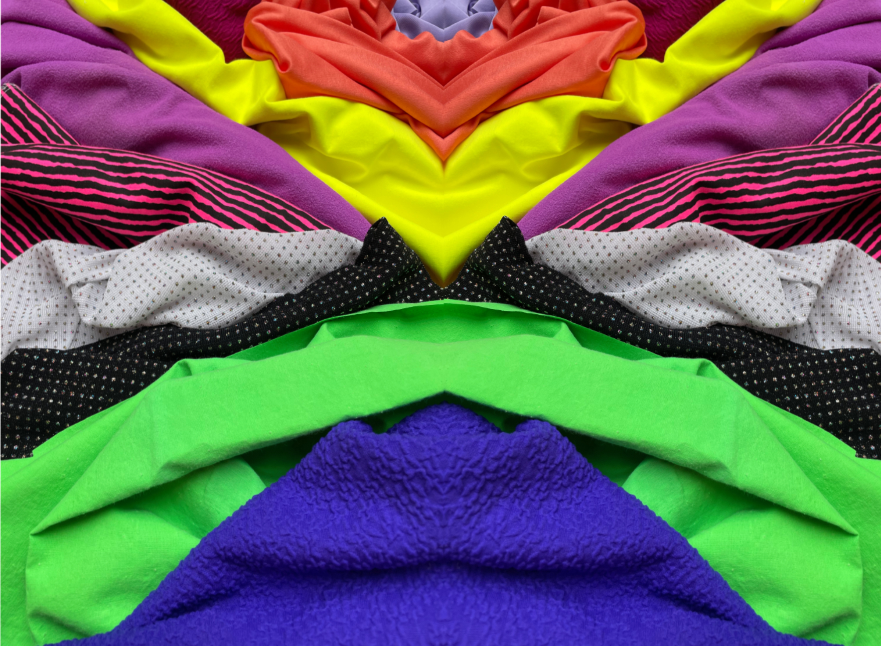 coloured fabrics stacked on top of each other to create a mirrored effect