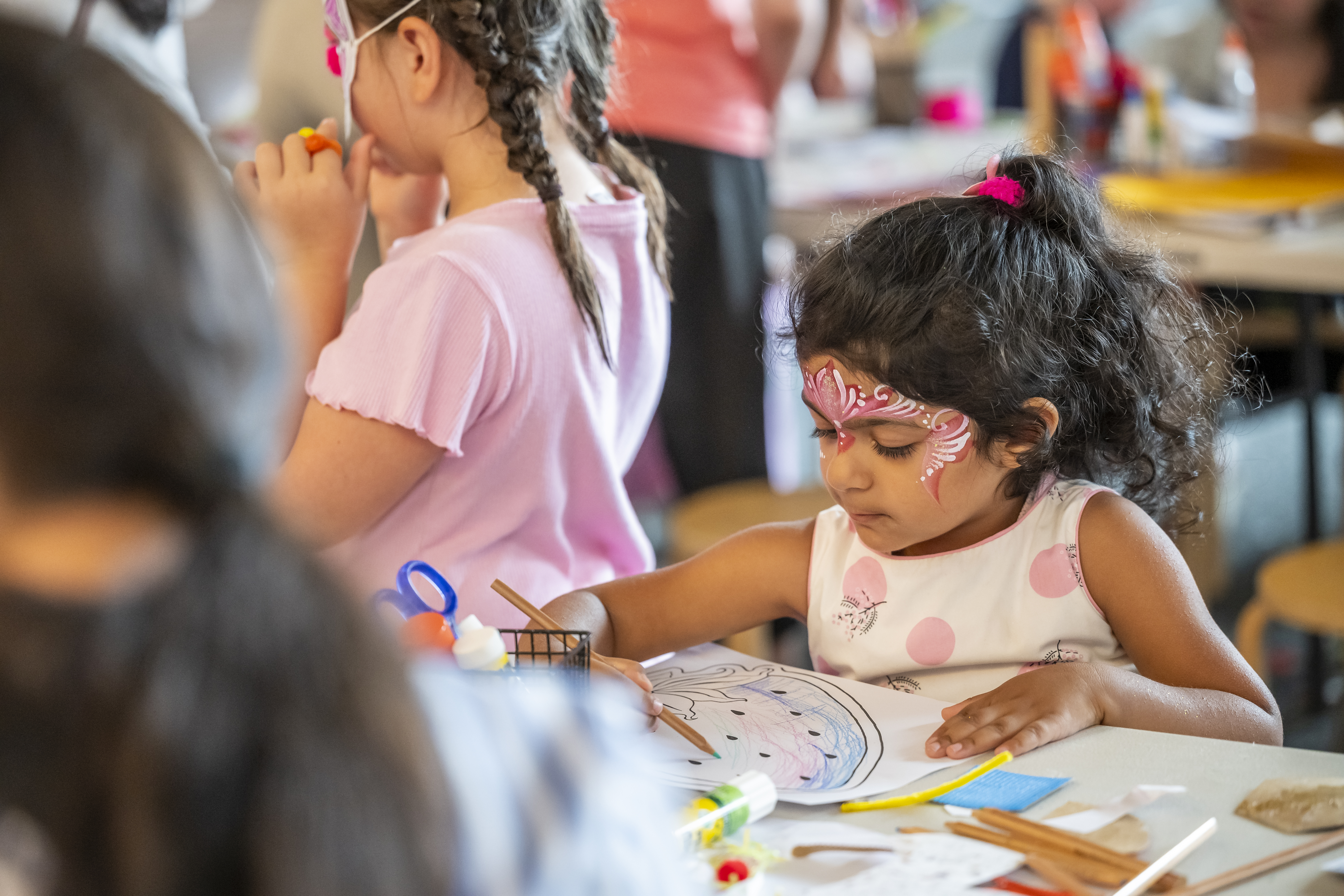 child colouring in an activity sheet