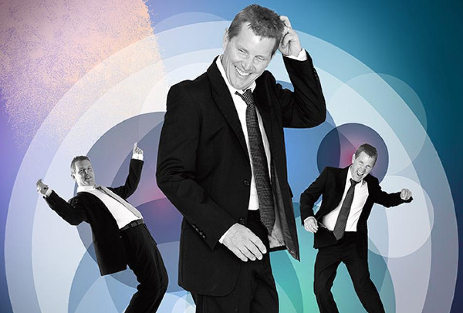 A man in a suit dancing, with his image replicated three times in different poses