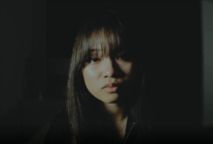 A woman's face, partially in shadow