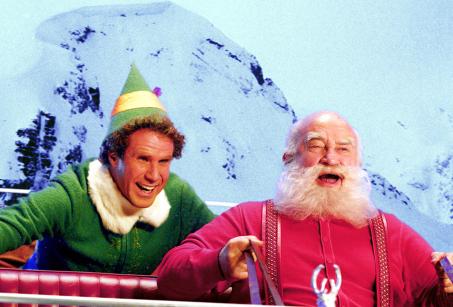 A man dressed as an elf, with a man dressed as Santa - an image from the Elf movie