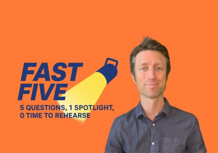 A portrait of a man in a grey shirt