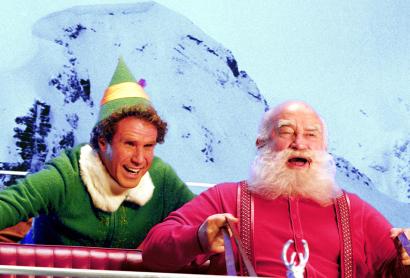 A man dressed as an elf, with a man dressed as Santa - an image from the Elf movie