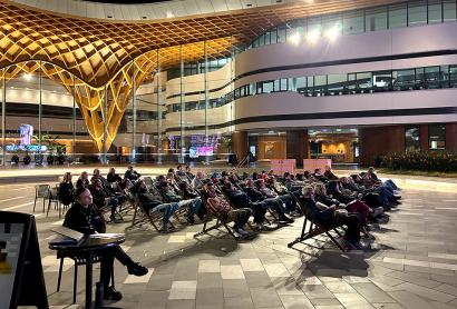 People sitting in an outdoor theatre for the Emergent Film Screening 