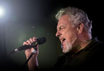 A man sings into a microphone