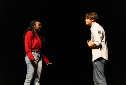 Two young actors performing on stage 